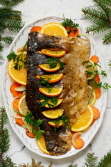 Traditional whole Polish Christmas carp with oranges and vegetables..top veiw