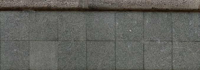 Panoramic texture of a stone tile wall with gray blocks