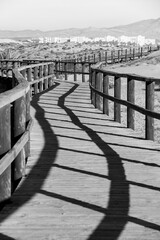 Obraz premium Wooden walkway to the beach in the morning in Alicante, Spain