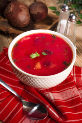 Red borscht soup in bowl.