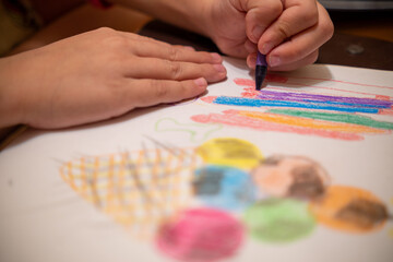 Fototapeta premium Draw with colored pencils on a white sheet of paper.