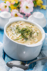 Tasty mushroom soup with noodles on a wooden table.