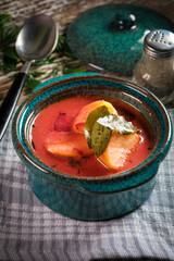 Red borscht soup in bowl.