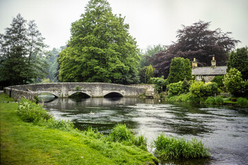 Vintage photograph of a stone bridge ove a river in the British countryside