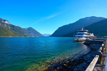 Beautiful landscape of lake Achen on a sunny day with pleasure boat. Austria, Tirol.