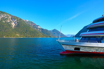 Beautiful landscape of lake Achen on a sunny day with pleasure boat. Austria, Tirol.