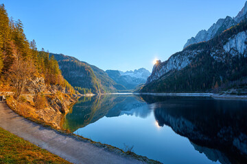 Beautiful Gosausee lake landscape with Dachstein mountains, forest, clouds and reflections in the water in Austrian Alps. Salzkammergut region