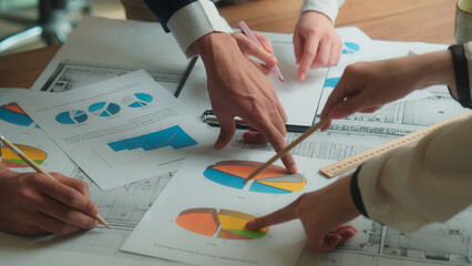 Paperwork on table office coworkers architects engineers contractors colleagues teamwork unrecognizable team business man women discussion architectural project documents blueprint graph plan on desk