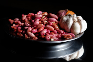 A pile of red beans on a stainless steel plate