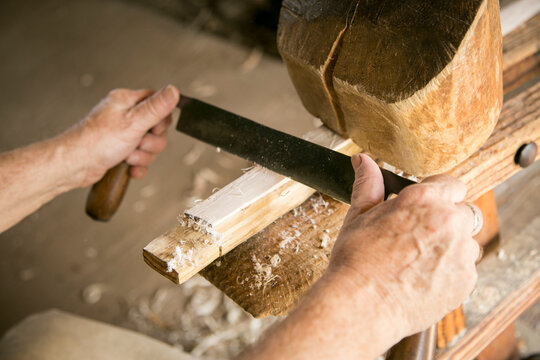 Mt. Pleasant, South Carolina. USA. Wood worker using period tools.