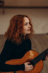 Fototapeta premium portrait of a red-haired woman playing the gatyr