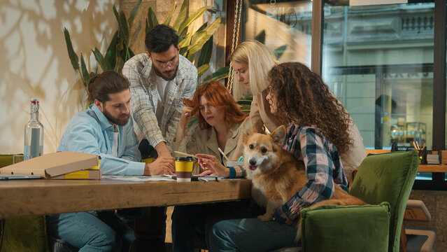 Multiethnic group creative pet dog friendly office coworking diverse team designers colleagues freelance coworkers business men women happy girls guys students friends talk study project drink coffee