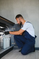 plumber change the water filter