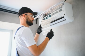 Repairman fix air conditioning systems, Male technicians service for repair and maintenance of air...