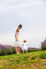 Happy mother and daughter in a lavender field