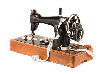 Sewing machine, measuring tape and spools of threads isolated on white