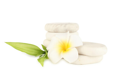Spa stones, plumeria flower and green leaves isolated on white