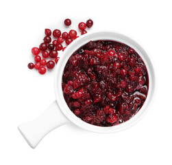 Tasty cranberry sauce in gravy boat and berries isolated on white, top view