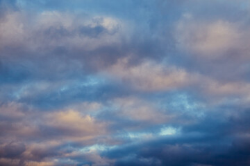 Fototapeta premium Winter morning: sunbeams light up gray clouds in the cold sky.