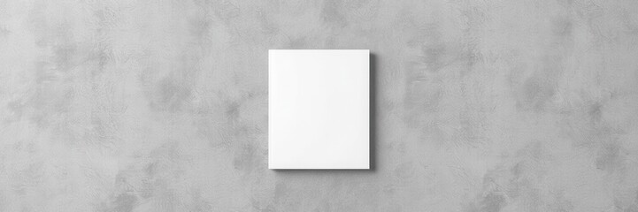 Hardcover book mockup displayed on concrete wall with minimalistic design elements, book, hardcover