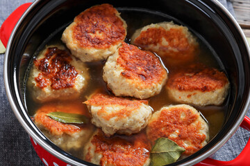 turkey potato cakes in a red pot, top view