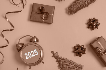 Flat lay 2025 new year alarm clock and gift boxes on mocha mousse colour background