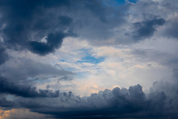 Dramatic pre-storm sky with orange hues blending into dark blue clouds. Atmospheric scene before storm