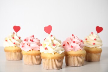 Tasty sweet cupcakes on white table. Happy Valentine's Day