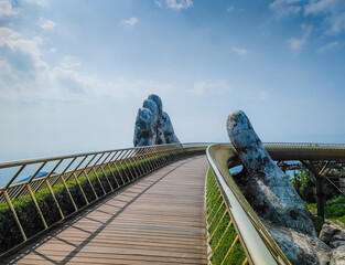 Golden Bridge in Ba Na hills, Da Nang, Vietnam on a sunny day. Lifted by two giant concrete hands....
