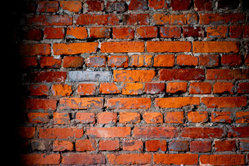 A weathered red brick wall showcasing raw texture and rustic charm, symbolizing resilience,...