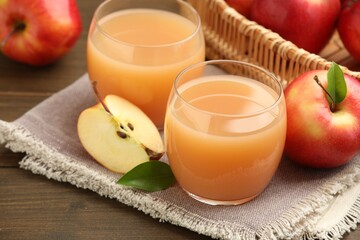 Tasty apple juice and fresh fruits on wooden table, closeup