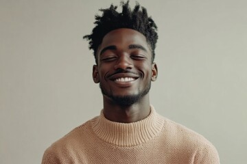 Obraz premium Joyful expression of a young man wearing a cozy sweater in a minimalistic indoor setting during a calm afternoon