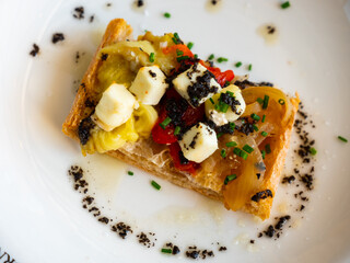 National Spanish coca de escalibada with goat cheese and black olives