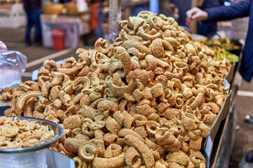 Fried pork cracklings piled high at a street market stall
