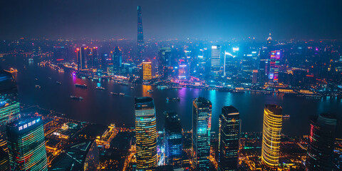 Fototapeta premium Vibrant city skyline illuminated at night with reflections on water in a bustling urban landscape