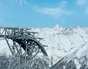Ski lift top and scenery at the snowy slopes (Tyrol, Austria).