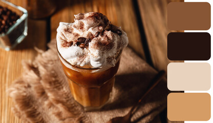 Glass of iced coffee on wooden table