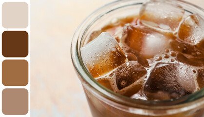Glass of ice coffee with milk on light background, closeup