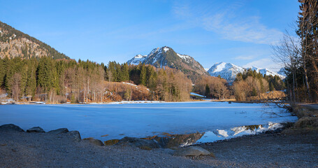 frozen lake Moorweiher, at the end of winter. landscape near Oberstdorf, bavaria