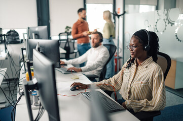 Customer service representative working in busy call center office
