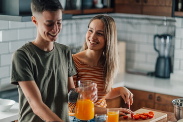 Lesbian couple preparing breakfast and having fun in the kitchen