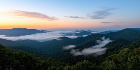 Obraz premium A serene landscape shot of rugged mountain tops piercing through a dense cloud layer