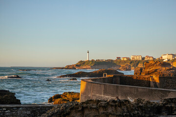 Biarritz coastline and a lighthouse at sunset