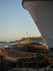 Biarritz coastline and a lighthouse at sunset