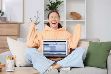 Happy teenage girl with college application on laptop at home