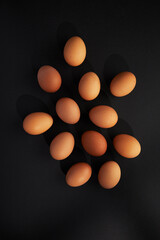 Chicken eggs on black background. View from the top