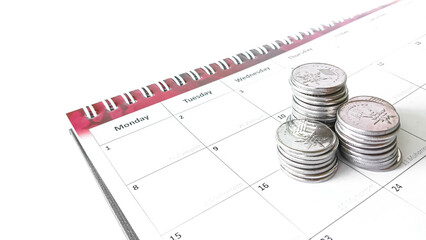 Image featuring a calendar and coins symbolizing budgeting and finances.