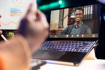African american man talking on video call using personal computer, discussing about accounting...