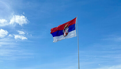 Serbian national flag waving on wind in a bright sunny weather