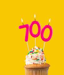 Pink candles forming the number 700 - Number of views, views or followers.
